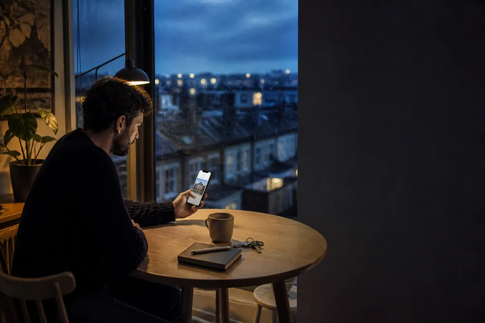 A buyer reviewing a new property match on their phone